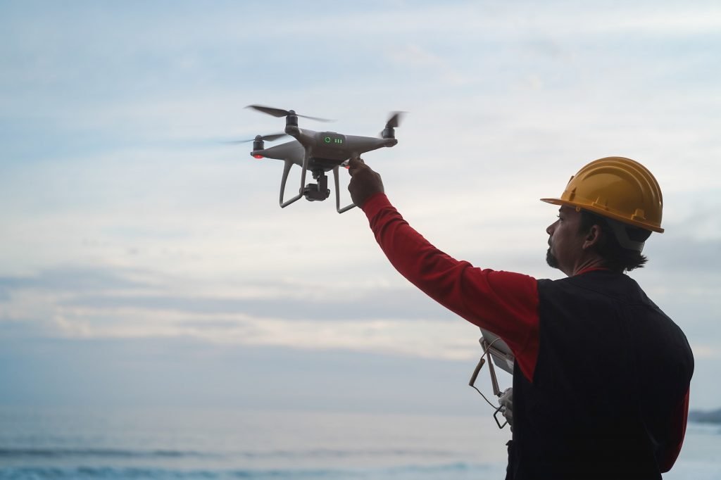 Engineer pilot man holding drone before flight - Focus on right hand